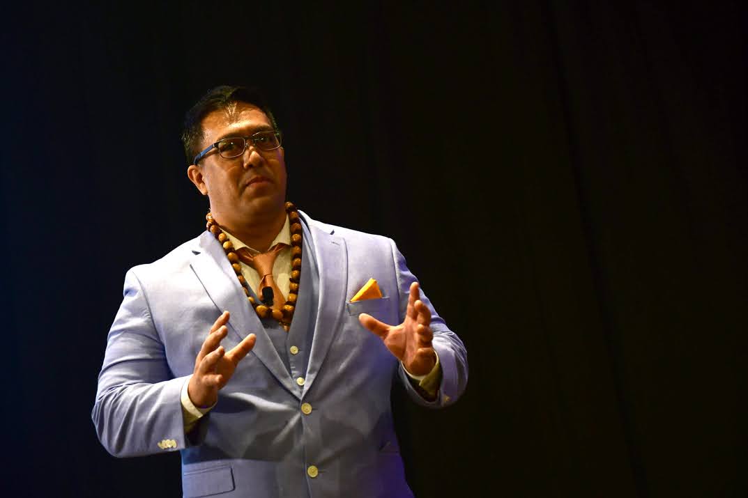 AJ Perkins speaking on stage